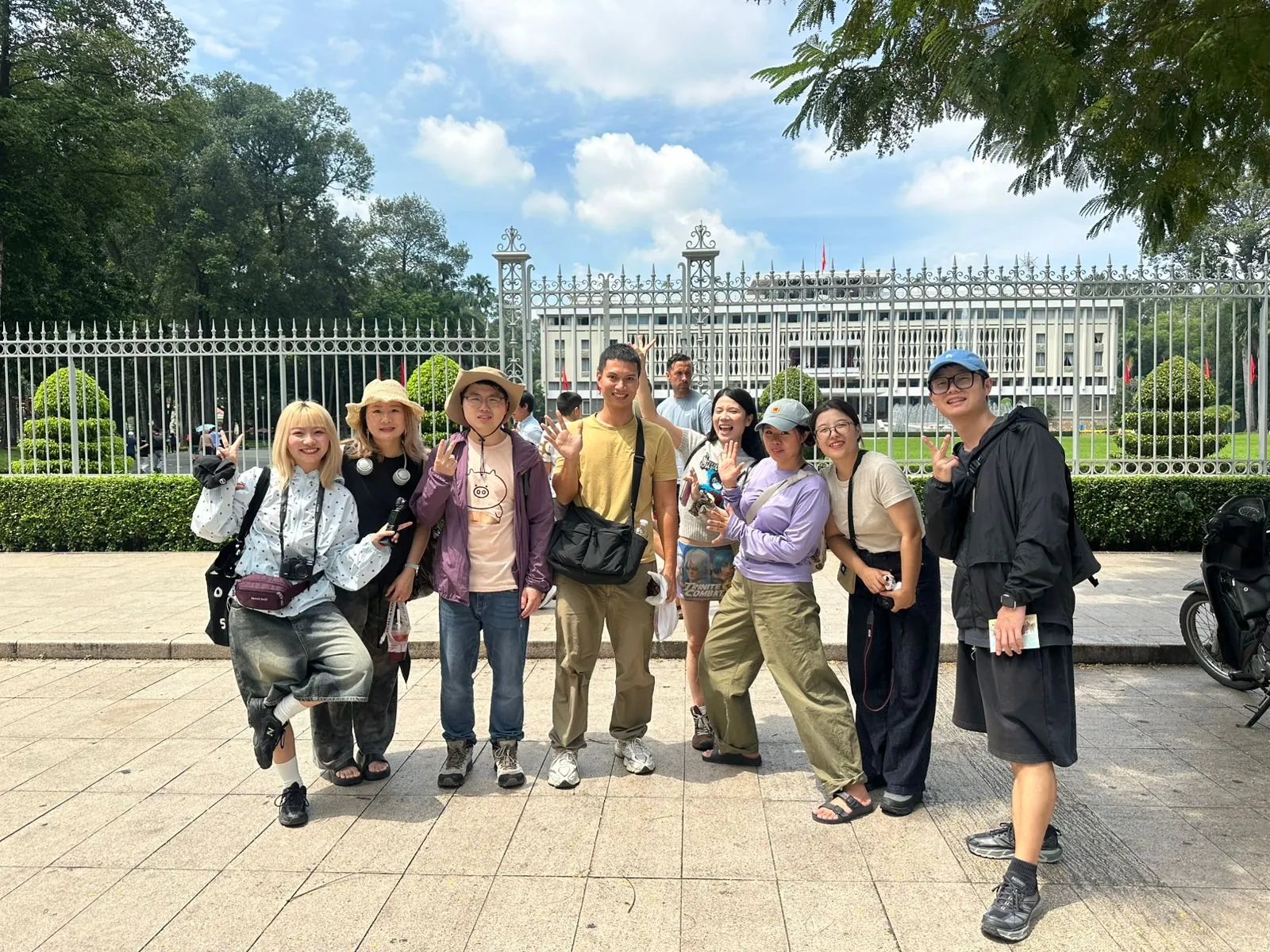 A large group of guests posing in front of the palace gate