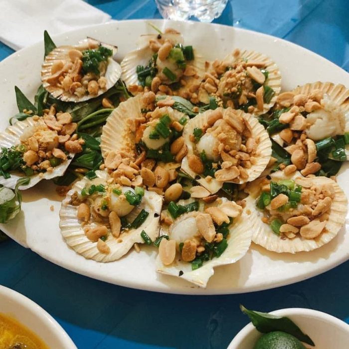 A platter of scallops grilled in the shell with spring onion oil and crushed peanuts